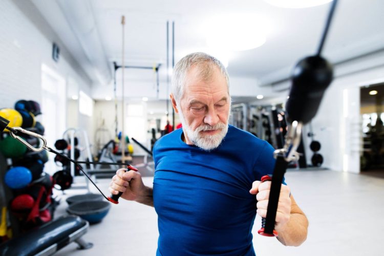 Senior male working out at the gym