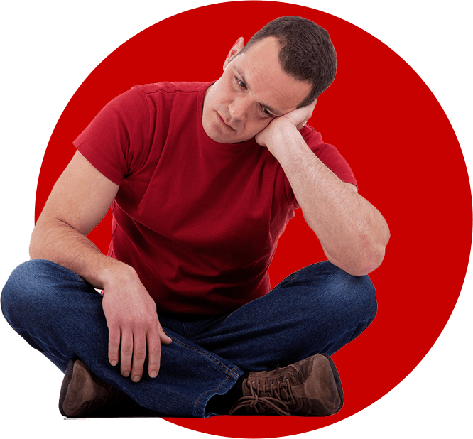 Man sitting cross-legged with a disappointed look
