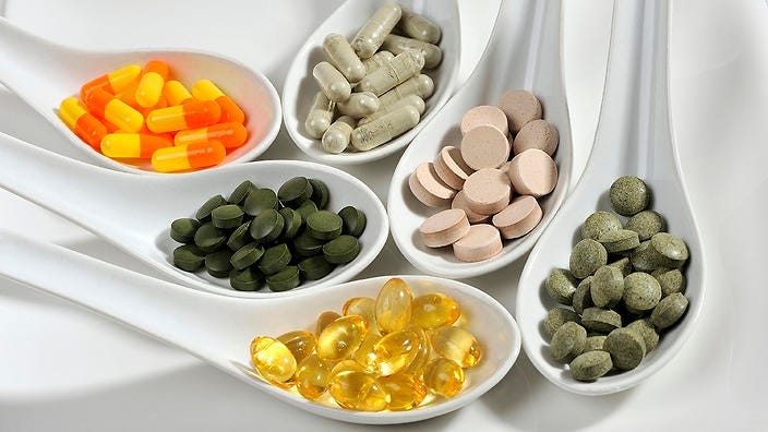 Various longevity pills supplements in a bright background