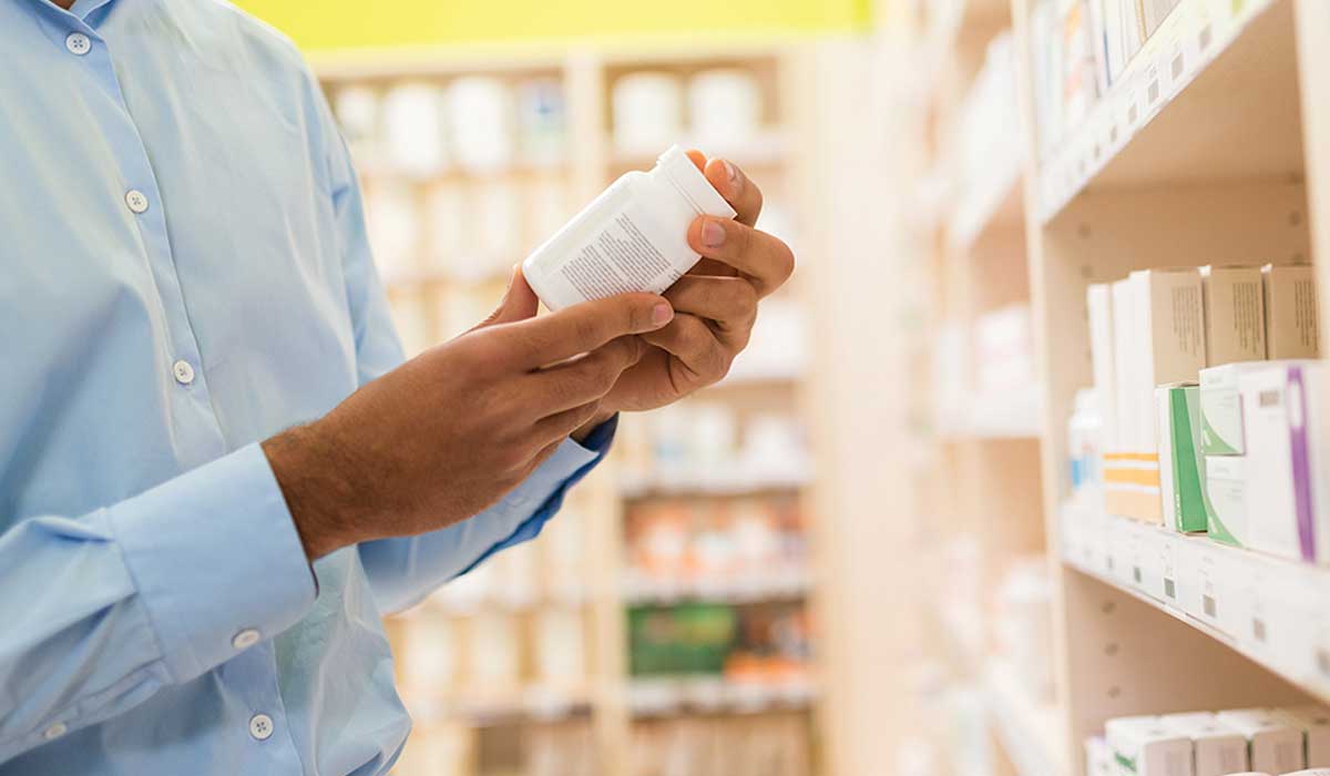 A man reading the benefits of using ashwagandha supplements