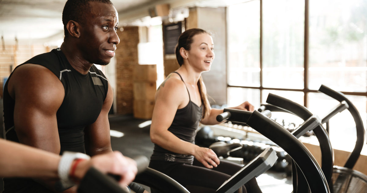 A man and a woman in the gym exercising