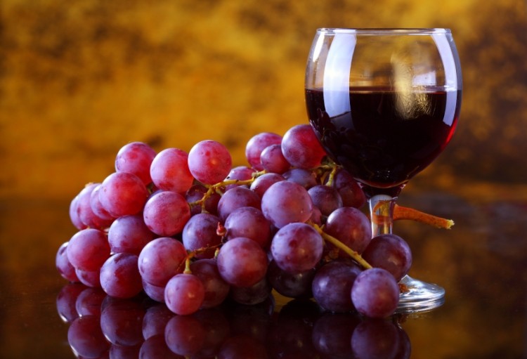 Grapes and a half-filled glass of wine