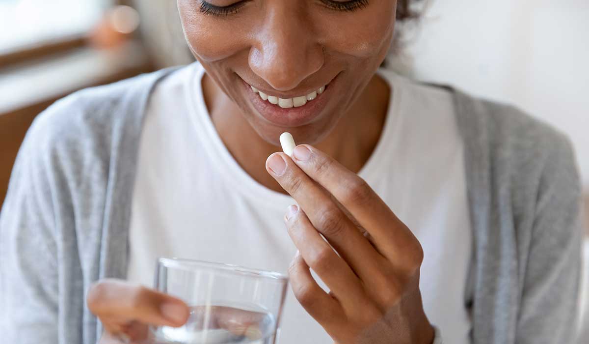 A woman taking resveratrol supplements