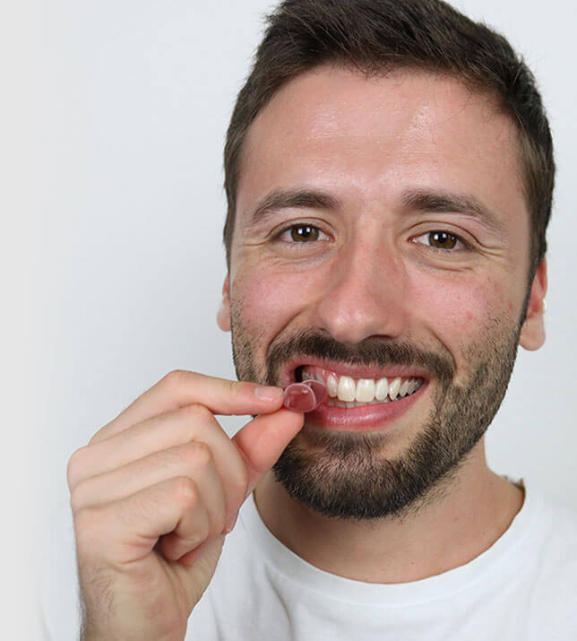 Man chewing Erectin Gummies