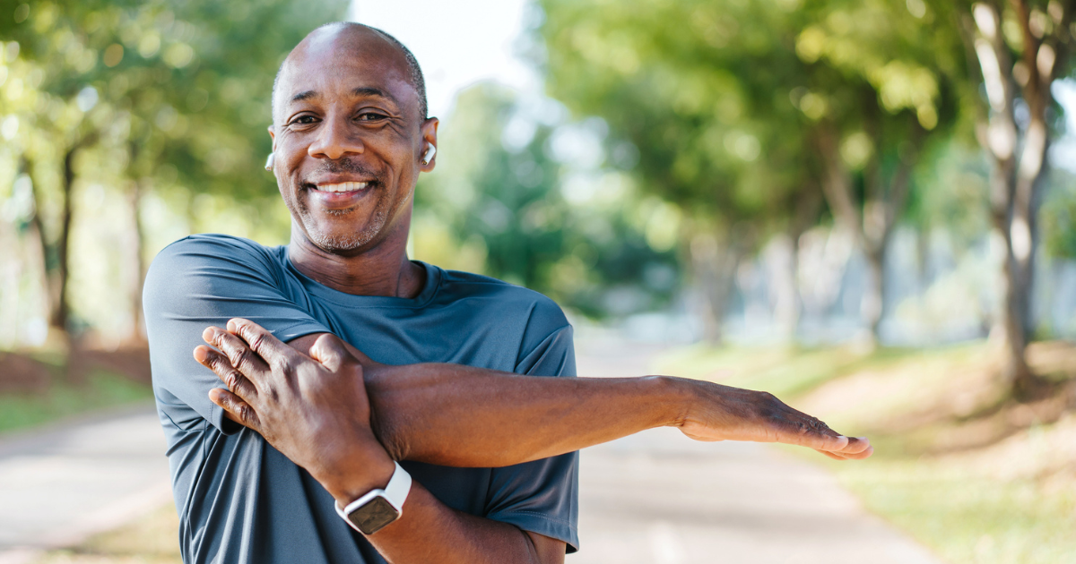 a man smiling and stretching